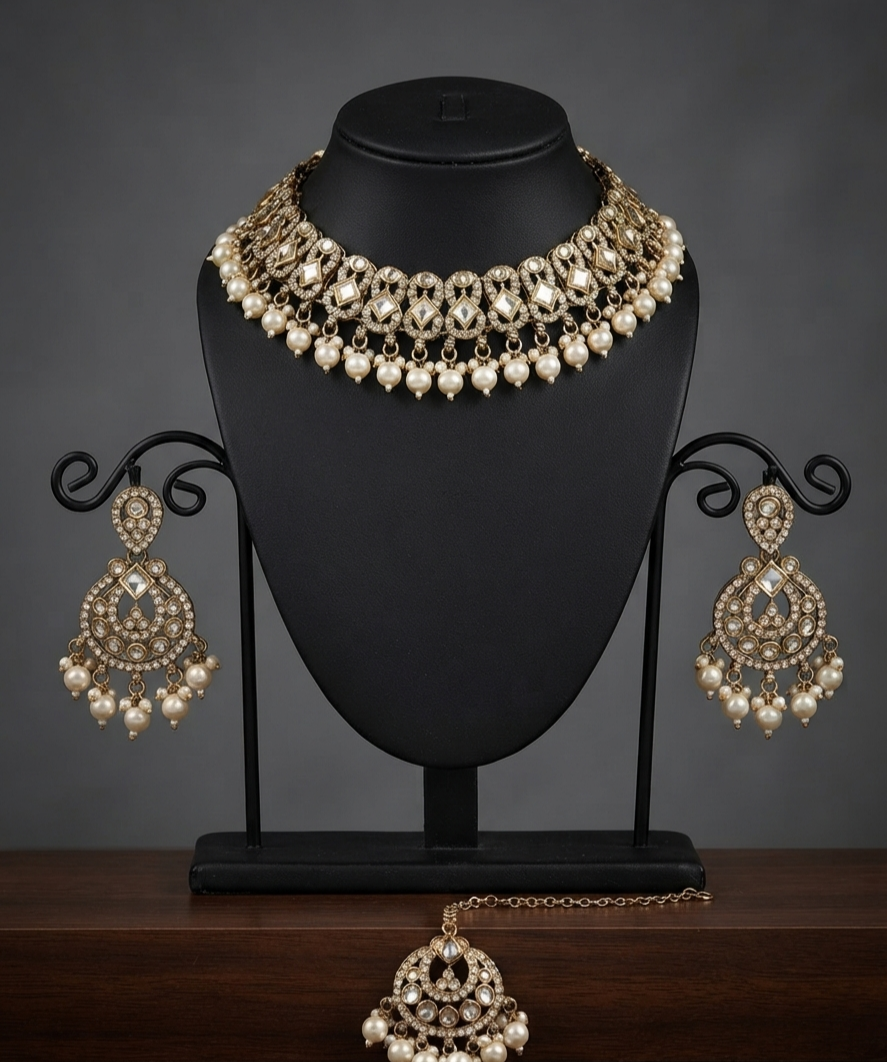 Antique Gold Kundan Jewelry Set With Elegant Pearl Drops.