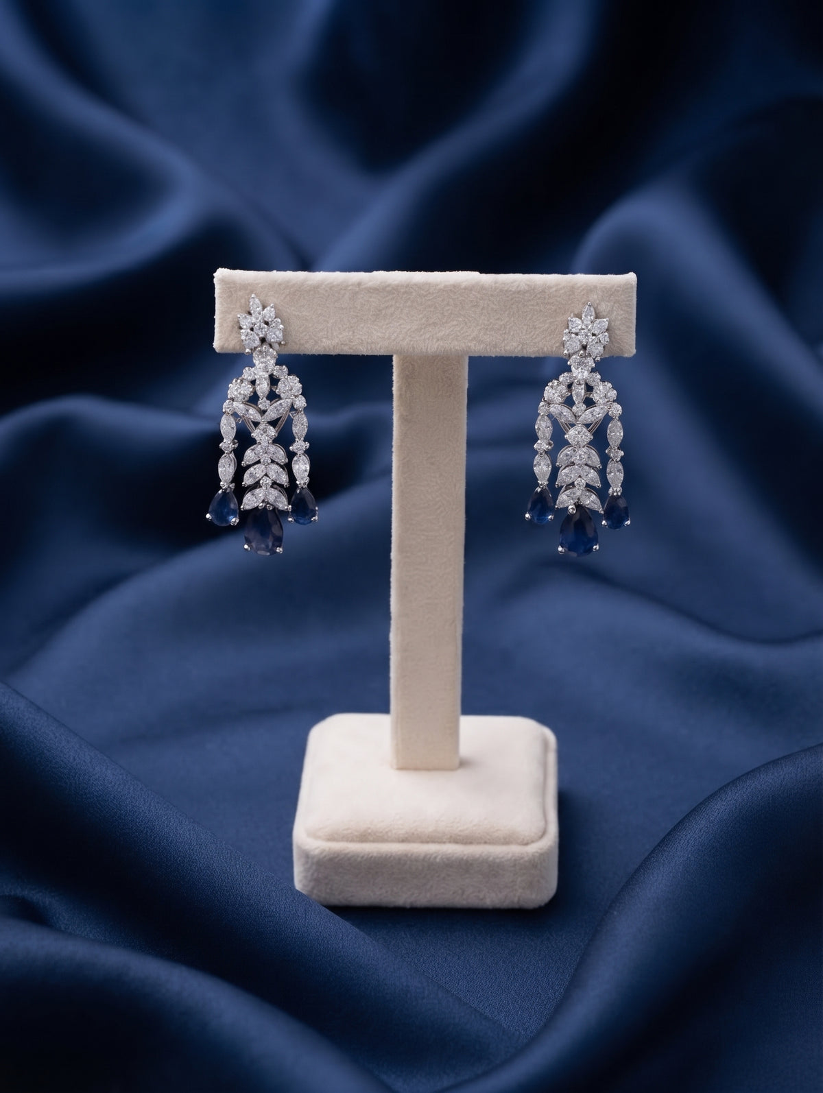 Elegant rhodium plated contemporary necklace and earring set with dark blue crystals featuring dazzling CZ crystals.