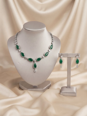 Stylish rhodium plated necklace and earring set adorned with sparkling emerald, green CZ crystals.