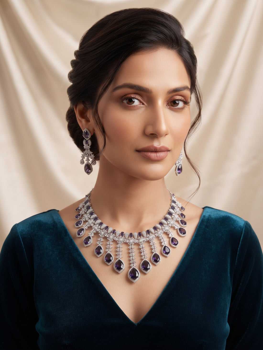 Stylish rhodium plated necklace and earring set adorned with sparkling purple CZ crystals.