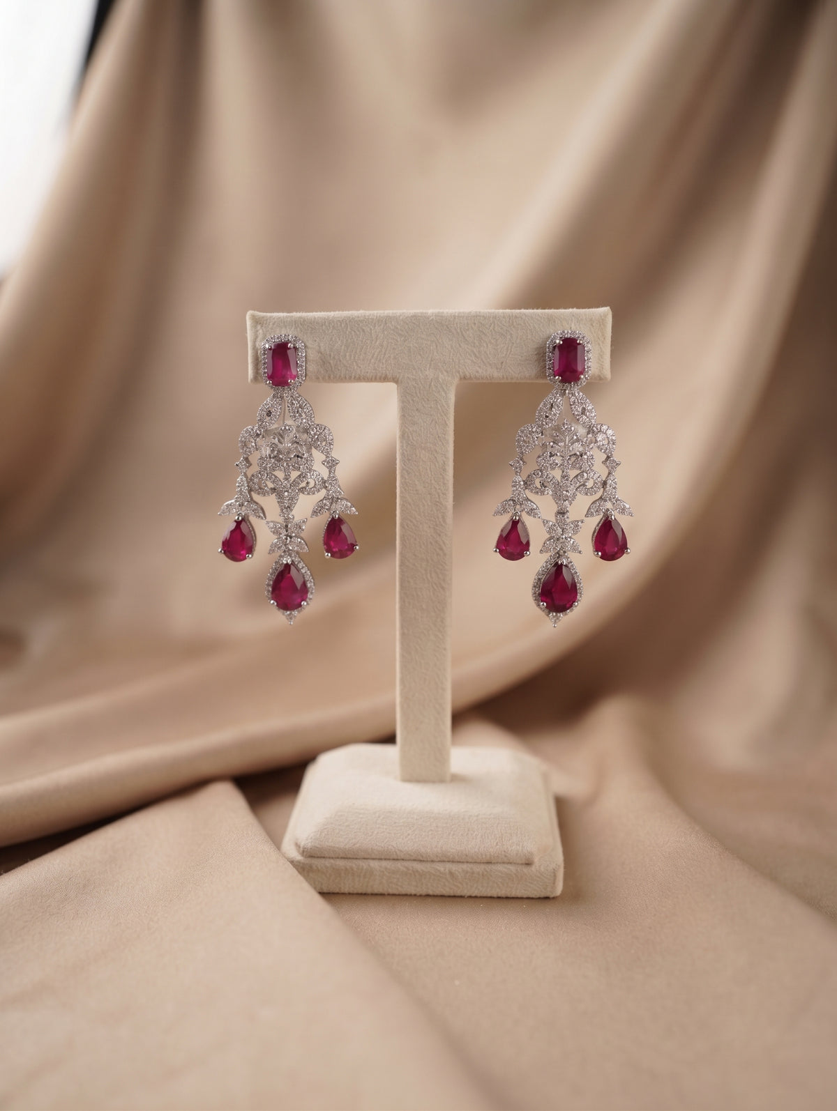 Elegant rhodium plated contemporary necklace and earring set with ruby crystals featuring dazzling CZ crystals.
