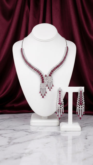 Rhodium plated necklace earing set with cubic zirconia and pink crystals
