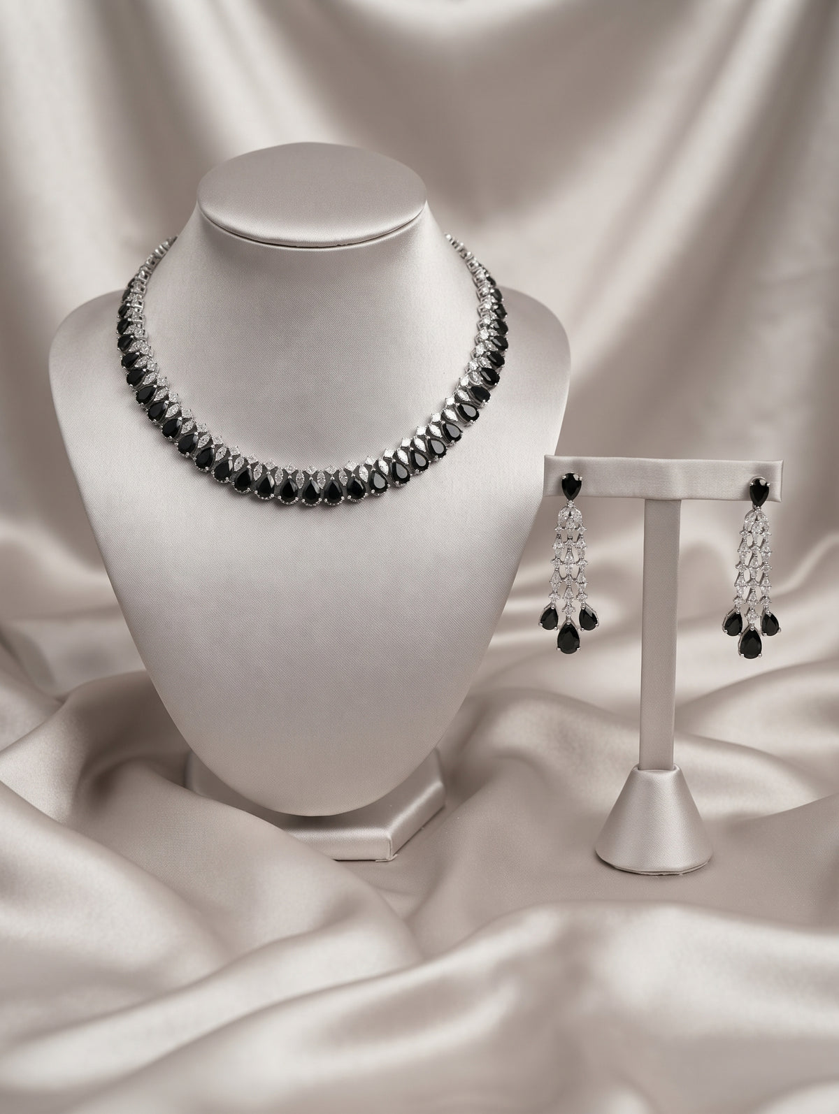 Stylish rhodium plated necklace and earring set adorned with sparkling black CZ crystals.