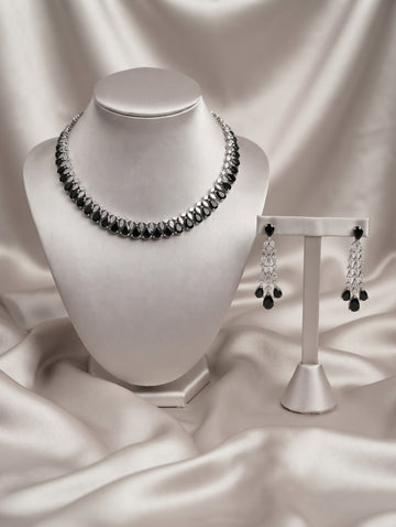 Stylish rhodium plated necklace and earring set adorned with sparkling black CZ crystals.
