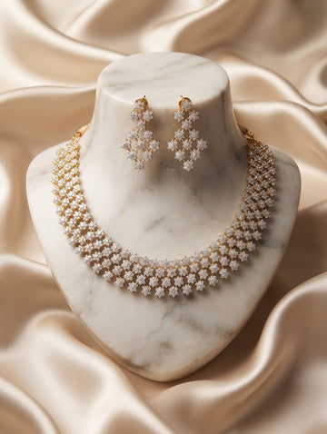 Modern gold-plated necklace and earring set with tika and with brilliant CZ crystals.