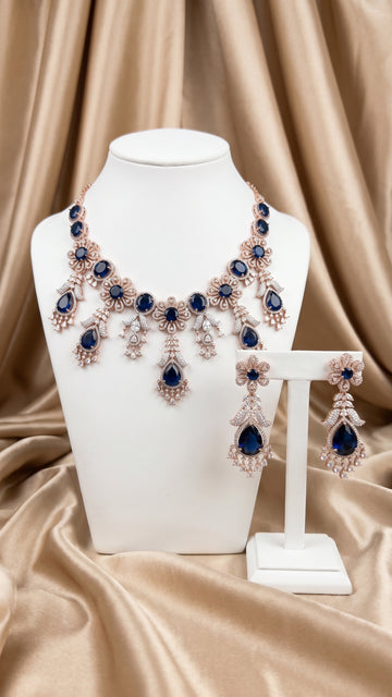 Rose gold plated necklace earring set with blue cubic zirconia crystals
