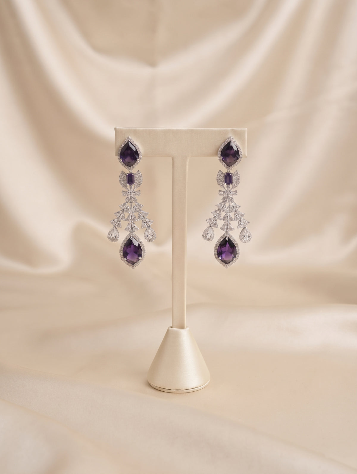 Stylish rhodium plated necklace and earring set adorned with sparkling purple CZ crystals.