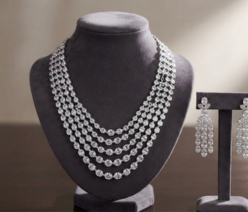 Rhodium layered necklace with matching elegant drop earrings.